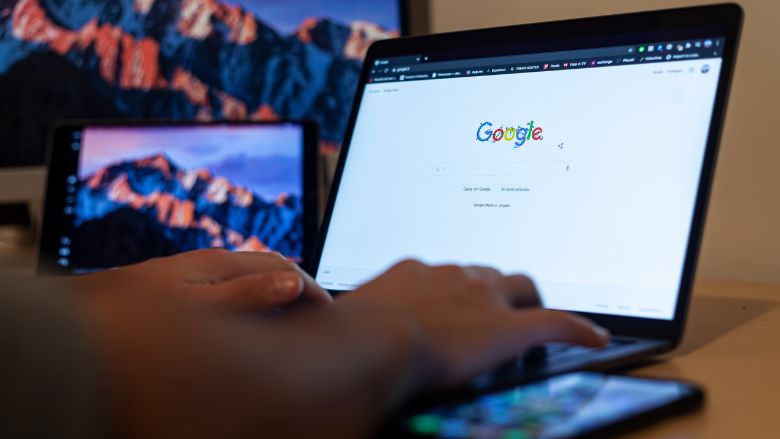 Close-Up Shot of a Person on a Laptop using Google