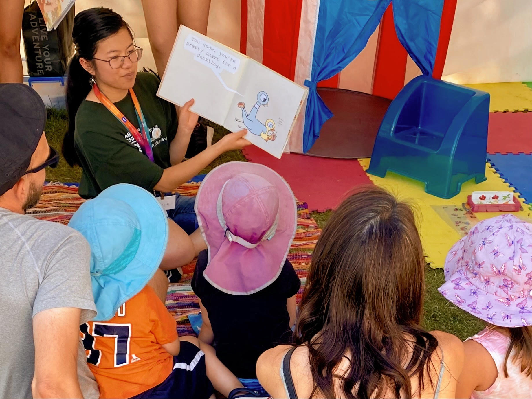 A volunteer read a book to a group of youth