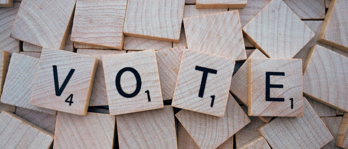 Scrabble tiles spelling vote