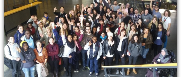 Group of young people waving at the camera