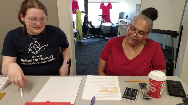 An adult learner works one-on-one with a United for Literacy tutor
