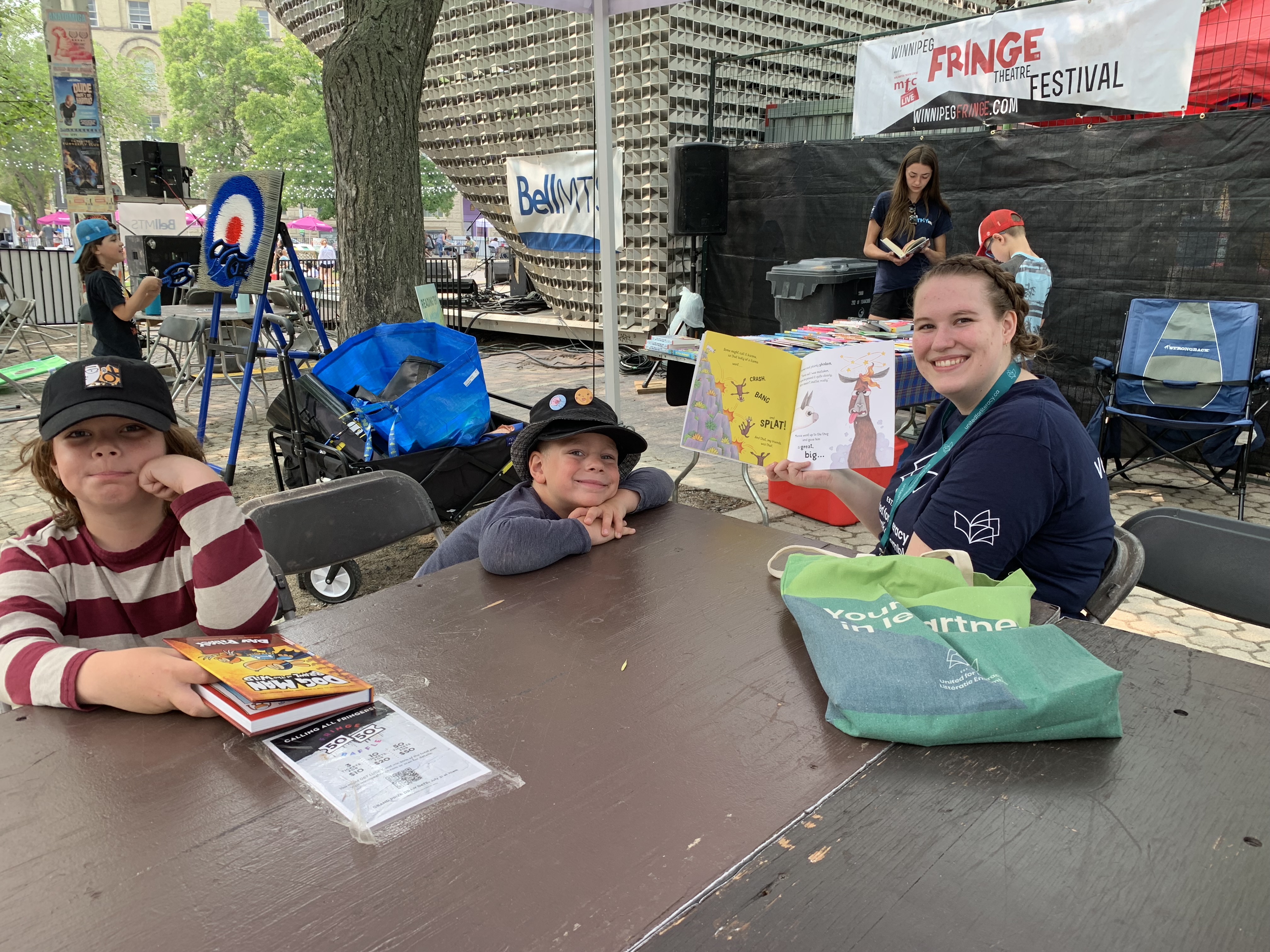 A woman and two kids reading a book